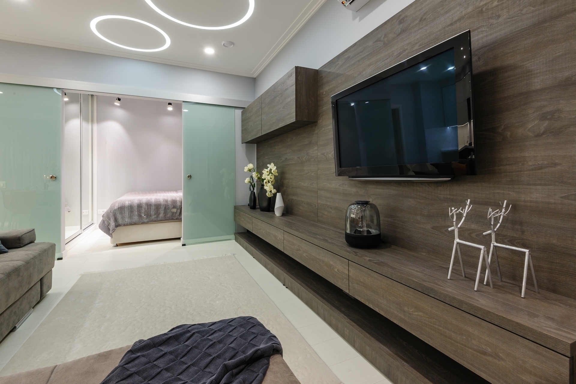 Modern white living studio with bedroom doors open